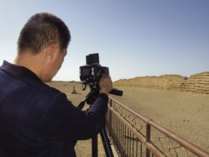 Dunhuang Academy photographer, Sheng Yanhai, photographing the Han-period wall near Dunhuang with the new P45 digital camera back.